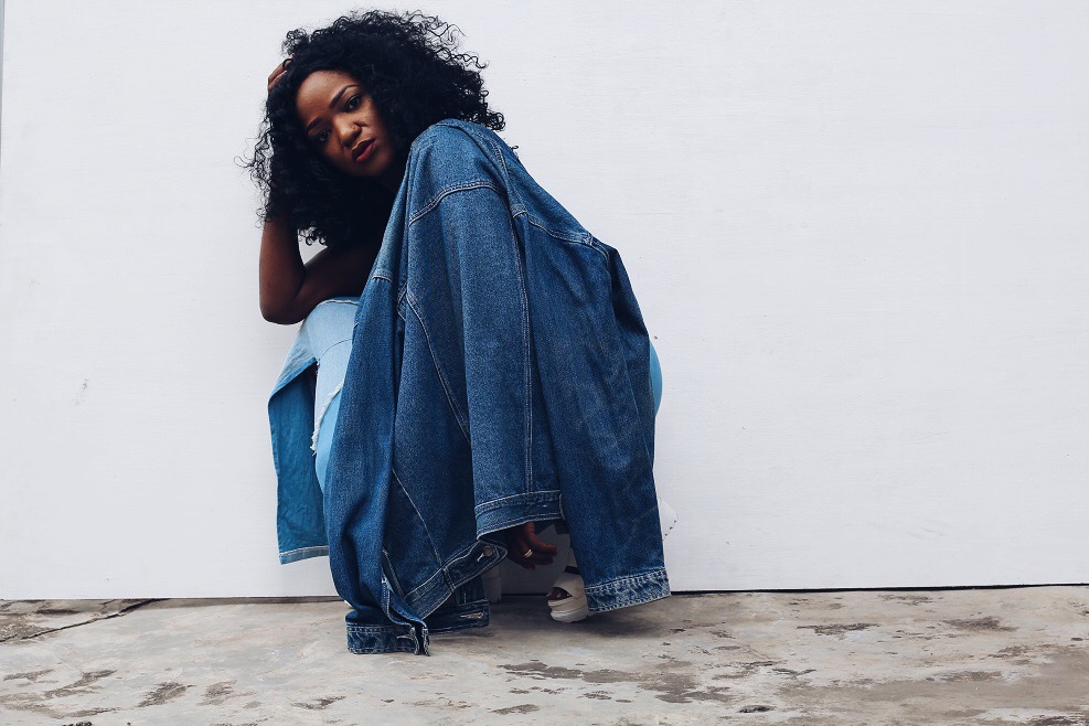 Girl holding head wearing denim on denim