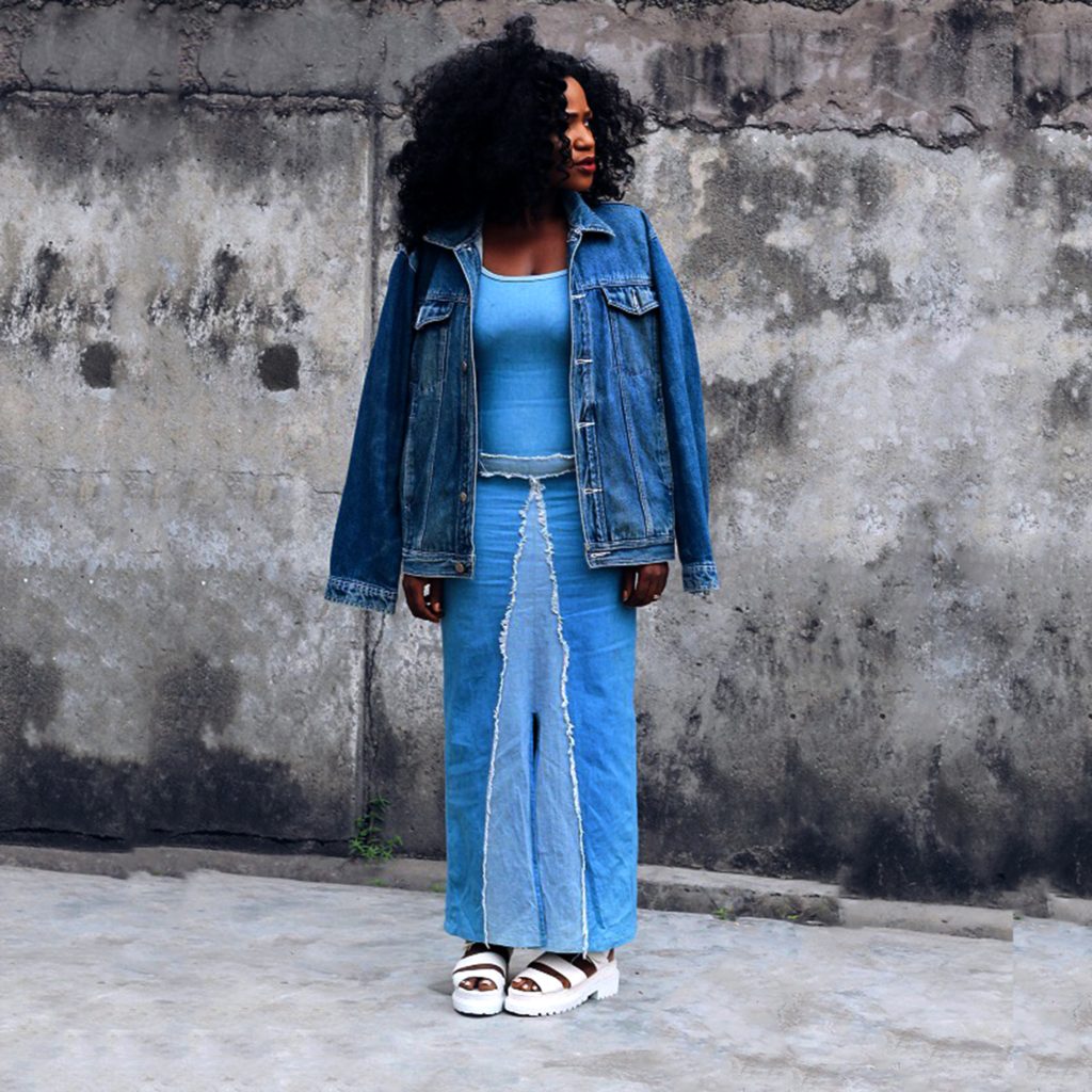 Girl looking away wearing denim dress and denim jacket