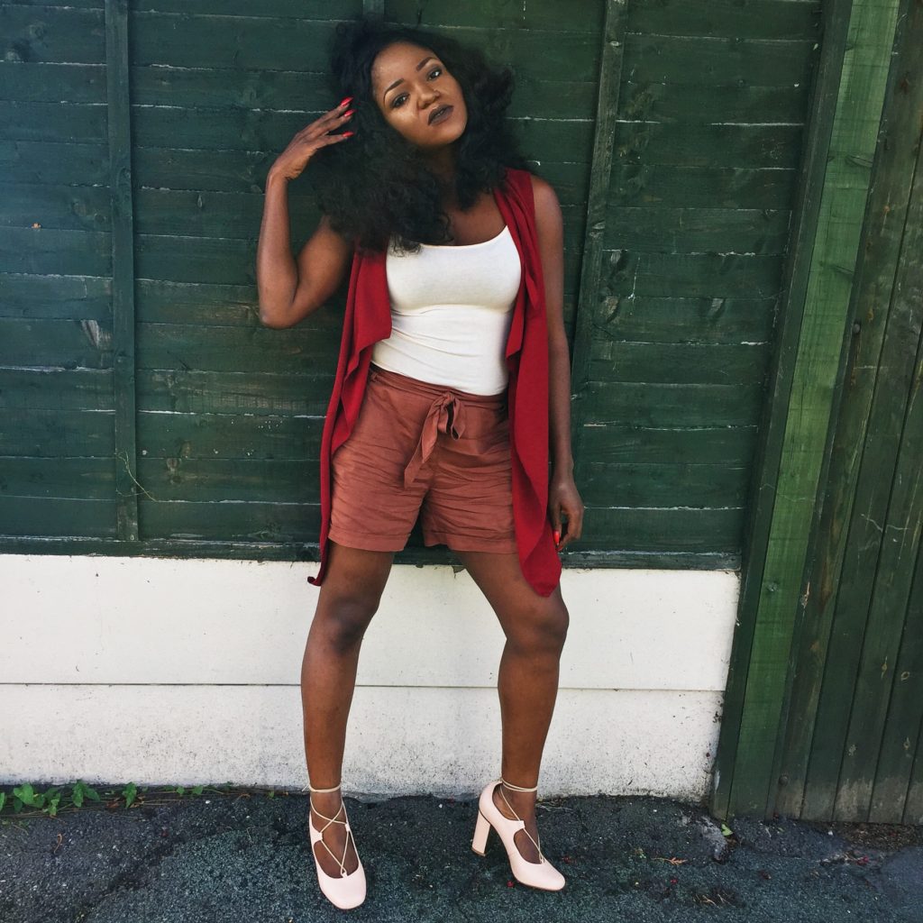 lady in burgundy jacket and nude ensemble