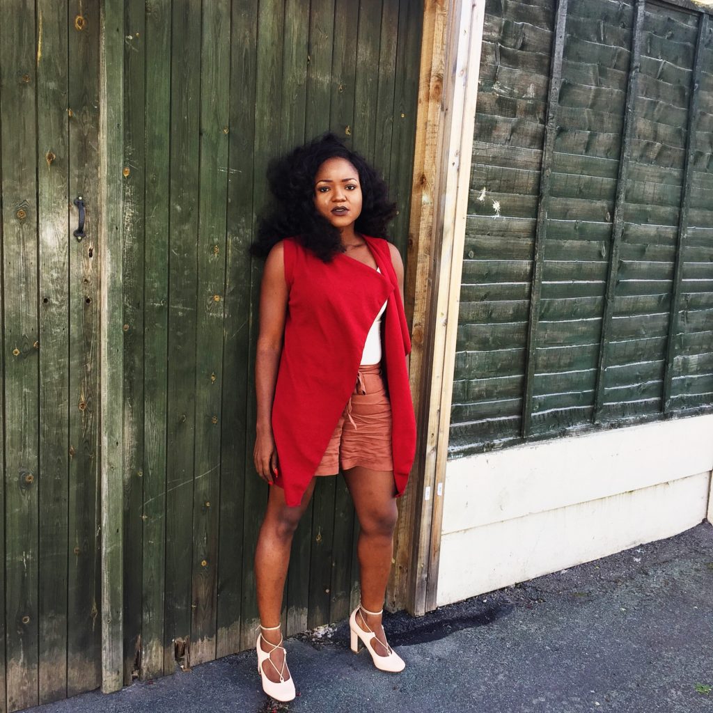 Lady wearing burgundy jacket and nude ensemble 