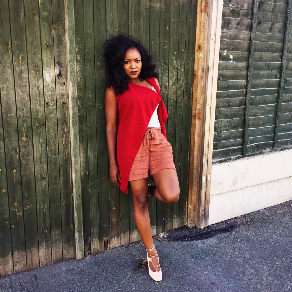 Lady wearing burgundy jacket and nude ensemble 