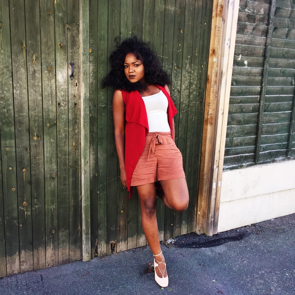 Lady wearing burgundy jacket and nude ensemble